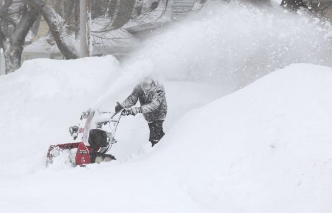 A person snow-blowing after a big snow storm